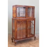 A 1930's china display cabinet with pull out shelf on cabriole legs