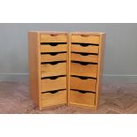 A pair of narrow teak utility chests of six drawers