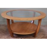 A 1970's style glass top circular coffee table