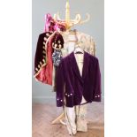 A collection of vintage clothing including a velvet jacket, a velvet cape and matching hat,