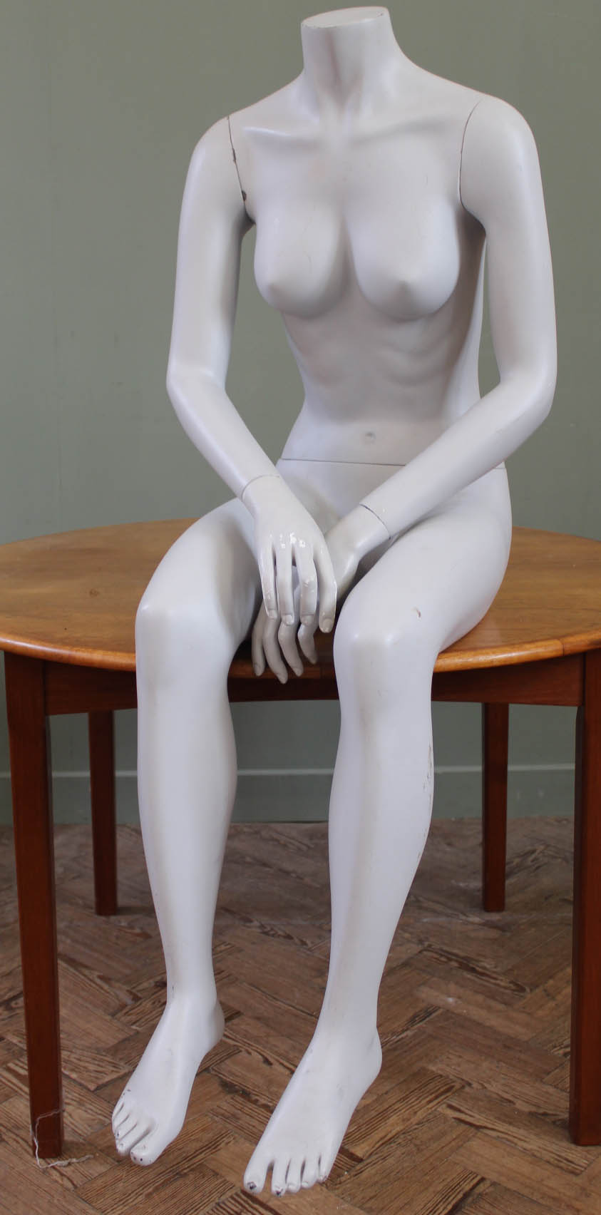 A vintage mannequin in the form of a headless seated woman