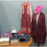 An assortments of vintage clothing including a 1970's dress, a jacket, handbags, hats,