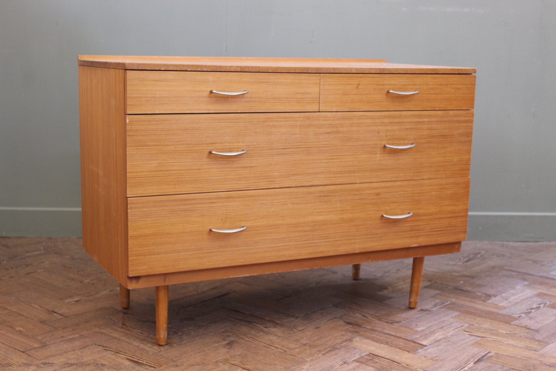 A 1970's chest of two short and two long drawers on round legs