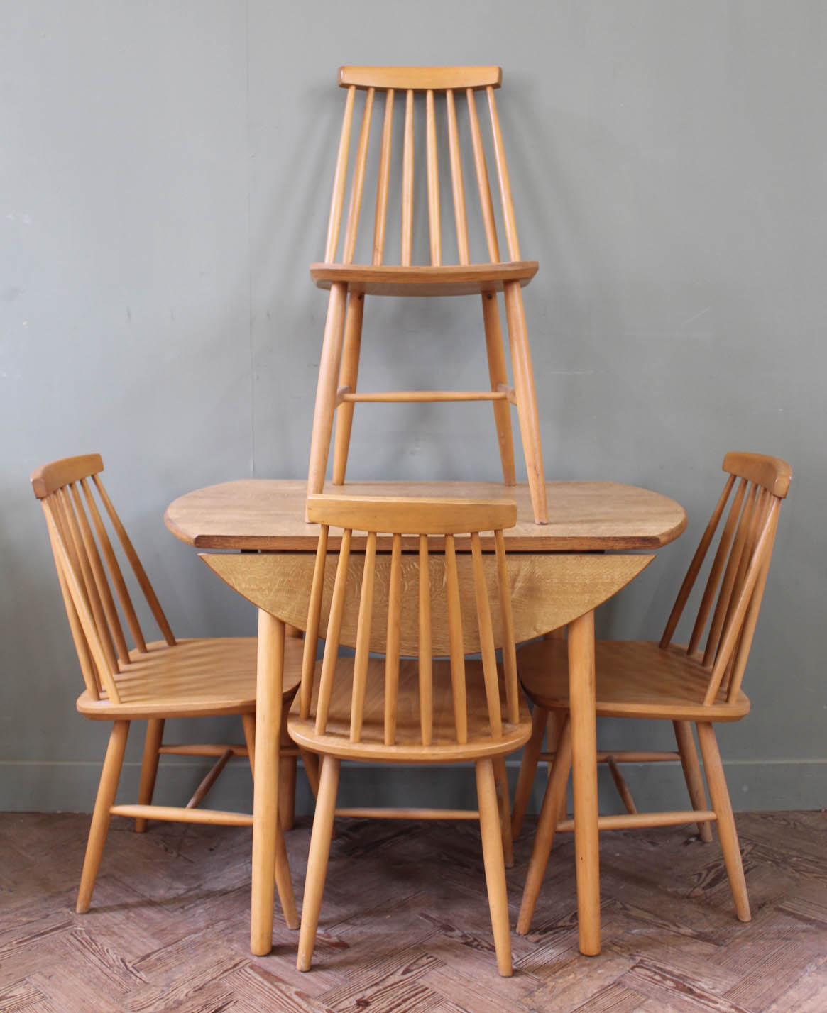 A small flap top Ercol style dining table and four chairs