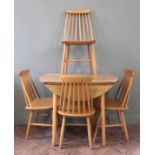 A small flap top Ercol style dining table and four chairs