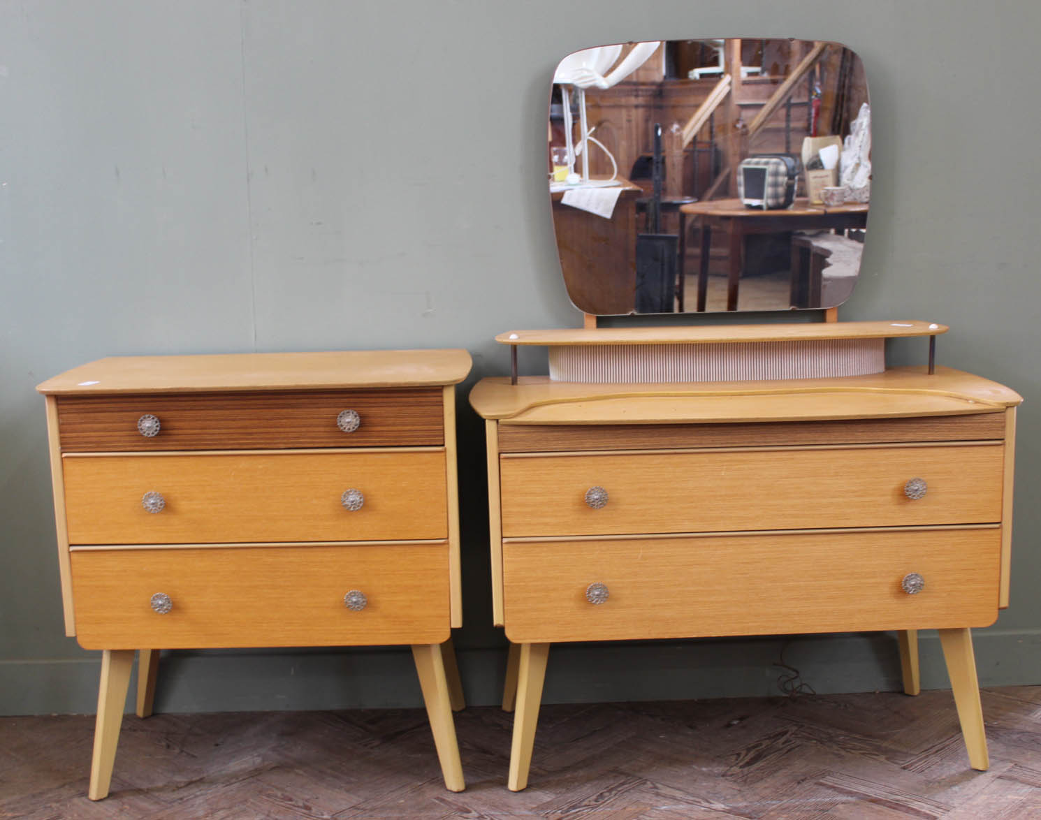 A 1950's dressing table with central lighting strip and a matching chest of drawers