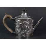 A silver teapot with later embossed decoration, wooden handle and finial, hallmarked London 1775,