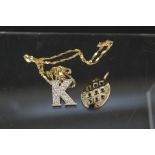 A large 9ct gold 'K' pendant set with white stones on 9ct gold chain together with a large yellow