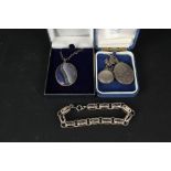 A large silver locket foliate decoration and enamelled silver locket on chains,