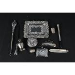 An embossed silver trinket dish, silver and white metal vesta cases, silver thimbles,