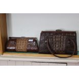 A crocodile skin handbag and clutch bag