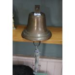 A brass ships bell plus a gymbal table lamp