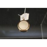 A yellow metal double photo locket,