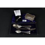 A matching silver spoon and fork, three silver teaspoons,