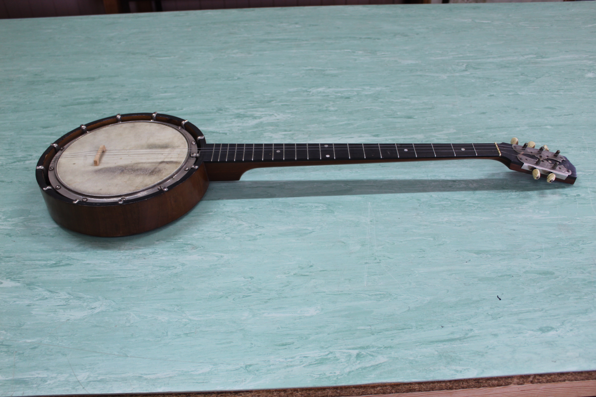 A cased American banjo with poker work decoration
