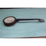 A cased American banjo with poker work decoration