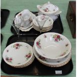 A porcelain rose decorated part dinner set plus a pair of engraved champagne glasses (two trays)