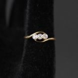 An 18ct gold three stone diamond ring, size R (as found,