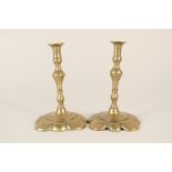 A small pair of brass petal base candlesticks,