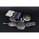 A mixed lot of silver and silver plated items including mirror, brushes,