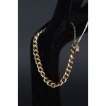 A 9ct gold curb link bracelet with 9ct gold heart shaped clasp