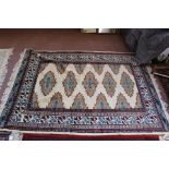 A Persian rug with repeating centre medallions,