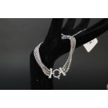 A 9ct white gold triple strand bracelet