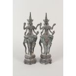A pair of Thai bronze deities on elephant supports,
