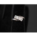 An 18ct gold and platinum three stone diamond ring,