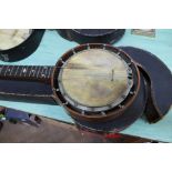 A cased five string banjo,