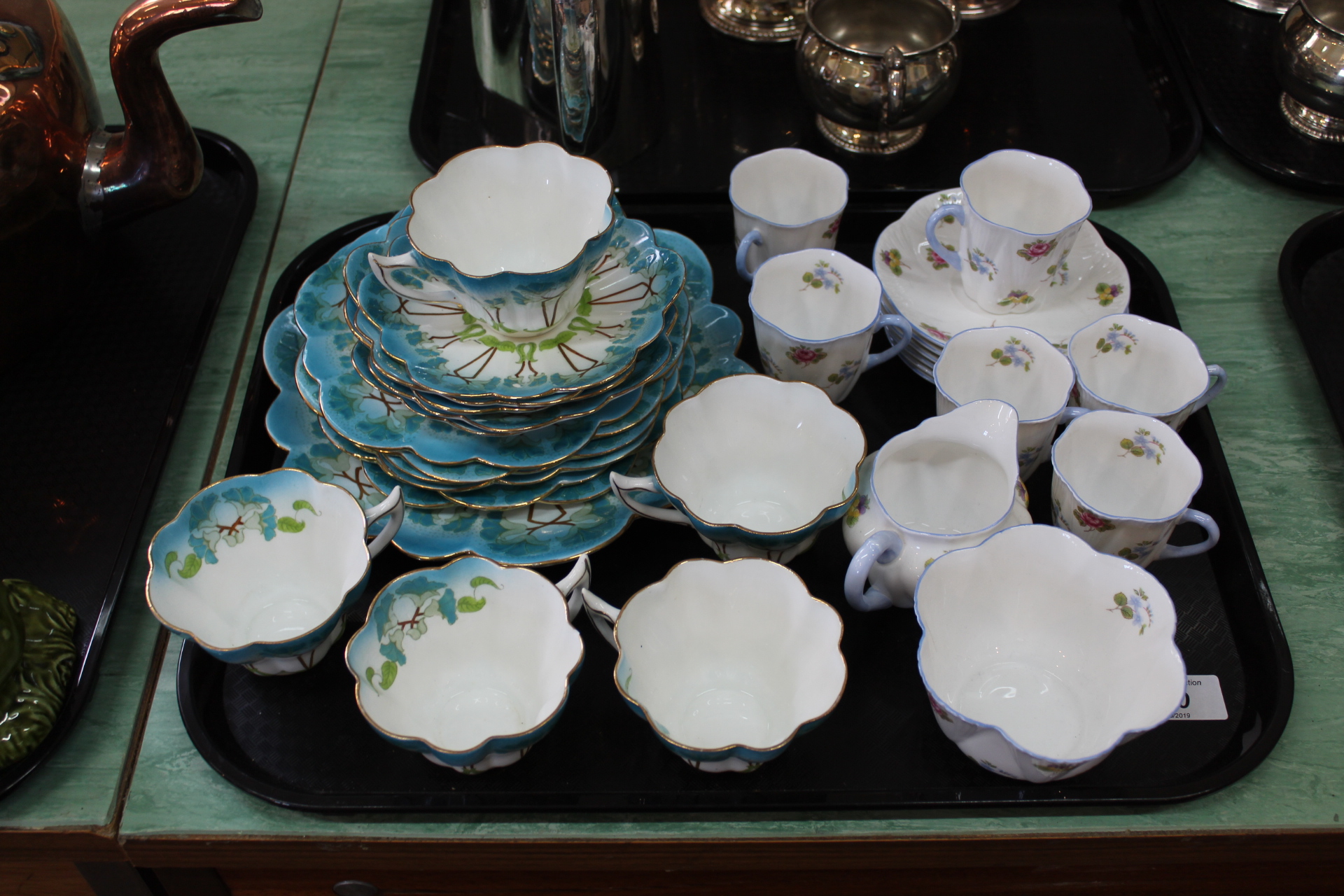 An Art Nouveau Wileman & Co snowdrop shape part service including a cake plate, six side plates,