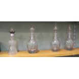 A set of three 19th Century cut glass decanters plus a silver rim thistle shaped decanter (as