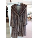 A lady's brown fur coat,