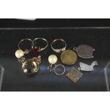 A mixed lot including two 9ct gold and silver stone set rings, a white metal paste set ring,