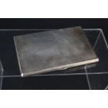 A large silver cigarette case with engine turned decoration