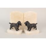 A pair of alabaster and metal dog mounted bookends
