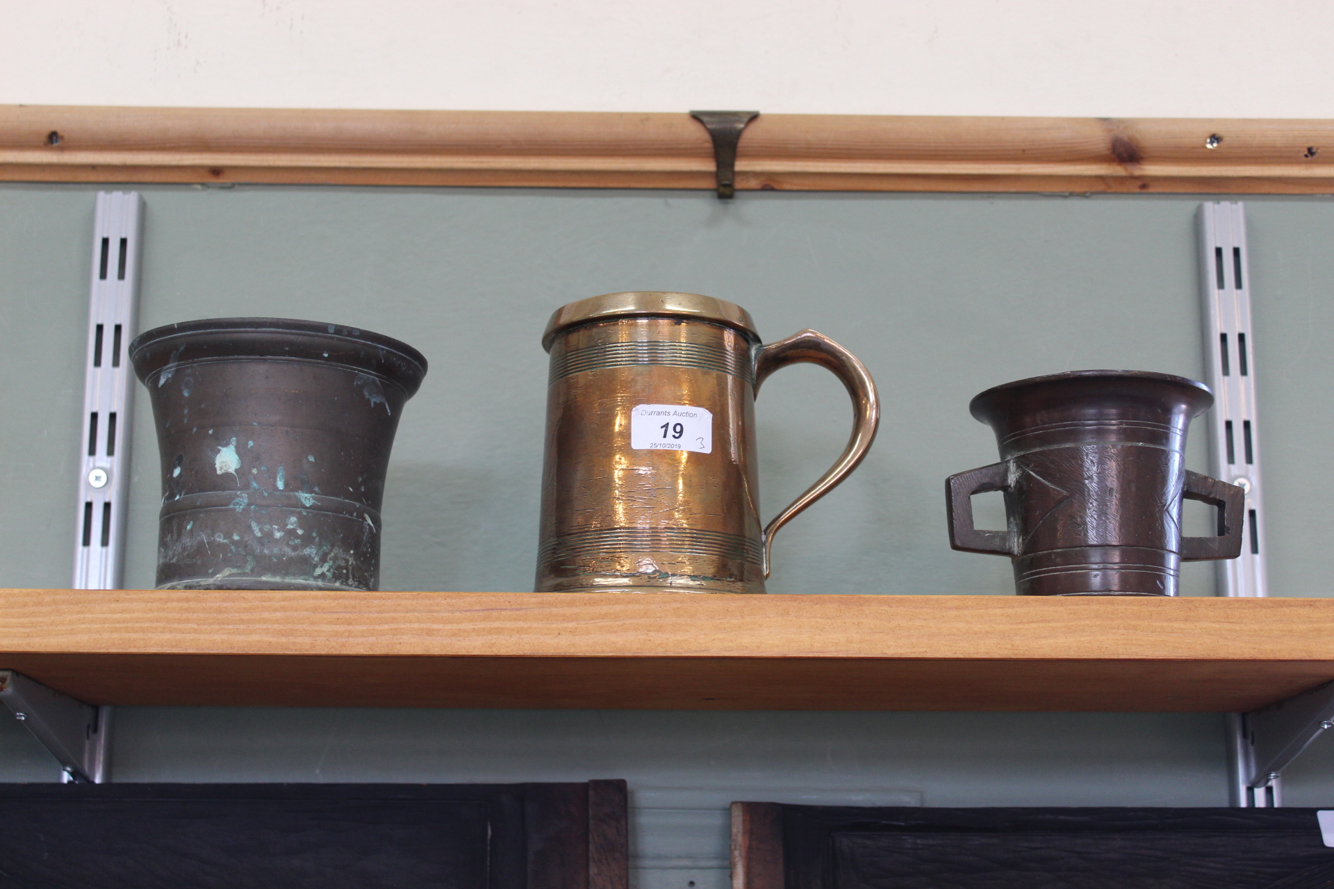 A 19th Century quart brass tankard with reeded decoration plus two 18th Century bronze mortars,