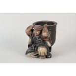 A Chinese pottery kneeling man supporting a large bowl, mark to base,