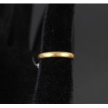 A yellow metal wedding band