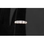 An 18ct gold five stone diamond ring interspersed with small rough cut diamonds,