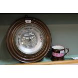 A circular mahogany aneroid barometer plus a Victorian pink splash lustre mug