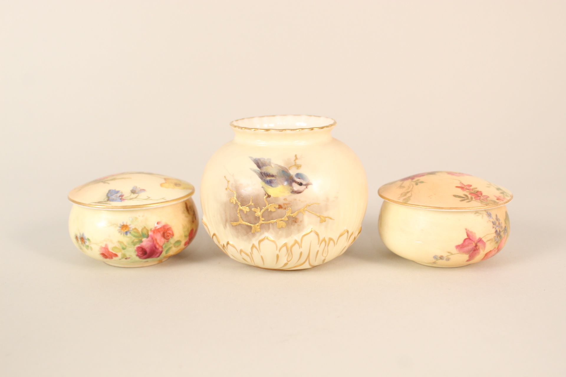 A Royal Worcester bird decorated vase plus two floral lidded pots (one as found)