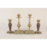 A pair of early 19th Century French embossed copper and brass dwarf candlesticks,