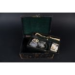 A leather clad jewellery box, green velvet interior,