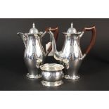A silver cafe au lait set consisting of a coffee pot, hot milk jug and sugar bowl,