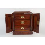 A Victorian walnut miniature three drawer chest enclosed by two doors