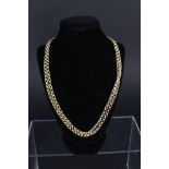 An opera length 9ct gold necklace consisting of interlocking textured circular lines