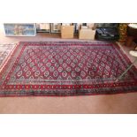 A Persian red ground rug,