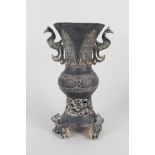 A Chinese metal vase on three animal supports,