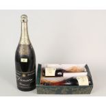 Two bottles of Paul Bocuse Cognac Reserve plus a bottle of Lanson Black Label Champagne